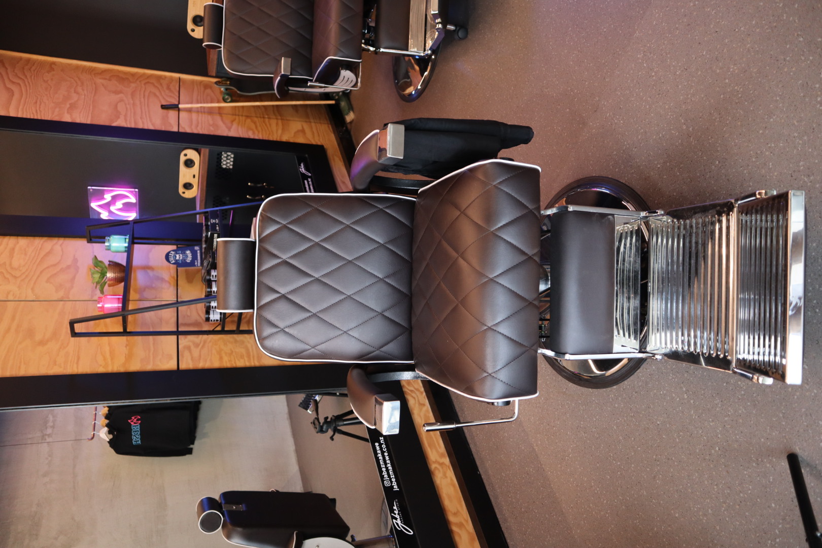 A barber chair and station inside Jabez Makawe Studio